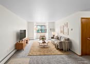 Thumbnail 6 of 39 - A living room with a grey couch and a wooden coffee table.