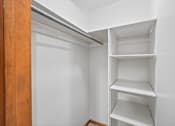 Thumbnail 9 of 39 - A white closet with shelves and a door.