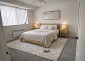 Thumbnail 24 of 36 - A bedroom with a large bed, a ceiling fan, and a window with blinds.