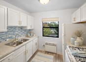 Thumbnail 31 of 36 - A kitchen with a window overlooking a bridge.