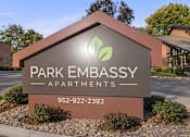 Thumbnail 44 of 58 - A sign for Park Embassy Apartments with a phone number on it.