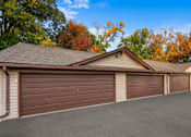Thumbnail 19 of 58 - A house with a brown garage door and a grey roof.