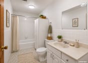 Thumbnail 53 of 58 - A bathroom with a toilet, sink, and shower.