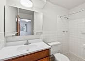 Thumbnail 41 of 58 - A white bathroom with a sink, toilet and shower.