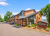 Thumbnail 4 of 58 - The image shows a building with the sign "PARK EMBASSY" in front of it.