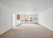 Thumbnail 37 of 58 - A room with white walls and a carpeted floor.