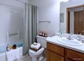 Thumbnail 31 of 59 - A white bathroom with a toilet, sink, and bathtub.