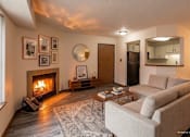 Thumbnail 50 of 59 - A living room with a fireplace and a couch.