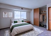 Thumbnail 34 of 59 - A bedroom with a large bed and a wardrobe.
