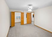 Thumbnail 39 of 59 - A room with two doors and a carpeted floor.