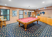 Thumbnail 23 of 59 - A pool table in a room with a blue carpet.