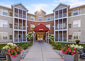 Thumbnail 54 of 59 - The image shows a beautiful day at the entrance of apartment building 1045 with a clear blue sky and sunlight shining through the windows.