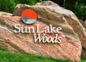 Thumbnail 2 of 59 - A large rock with the words Sun Lake Woods written on it.