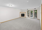 Thumbnail 42 of 59 - A room with a grey carpet and a television set.