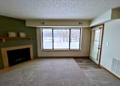 Thumbnail 41 of 59 - A room with a fireplace and a window.