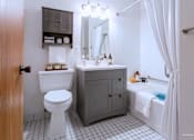 Thumbnail 32 of 59 - A bathroom with a white toilet and a white sink.