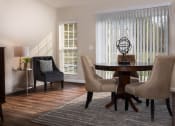 Thumbnail 6 of 9 - a living room with a table and chairs