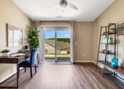 Thumbnail 6 of 9 - an office with a sliding glass door and a view of a house