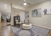 Thumbnail 9 of 10 - a living room with a ceiling fan and a rug