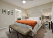 Thumbnail 7 of 10 - a bedroom with a bed and a bench in front of a closet