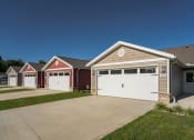Thumbnail 1 of 11 - a row of houses with white garage doors