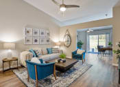 Thumbnail 4 of 11 - an open living room with a couch and chairs and a ceiling fan