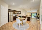 Thumbnail 5 of 11 - a kitchen and dining room with a table and chairs