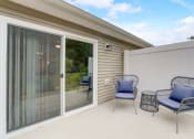 Thumbnail 11 of 11 - a patio with two chairs and a table and a sliding glass door