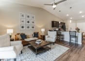 Thumbnail 5 of 8 - a living room with couches and chairs and a table