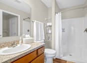 Thumbnail 13 of 15 - A bathroom with a sink, toilet, and bathtub.