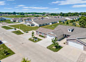 Thumbnail 12 of 15 - A bird's eye view of a residential area with houses and driveways.