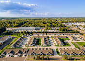 Thumbnail 19 of 20 - A bird's eye view of a residential area with houses and a parking lot.