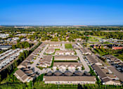 Thumbnail 20 of 20 - A bird's eye view of a residential area with houses and parked cars.