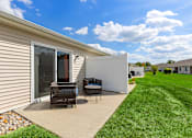 Thumbnail 17 of 20 - A house with a patio and a white wall.