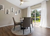 Thumbnail 13 of 21 - A dining room with a table and chairs.