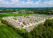 Thumbnail 21 of 21 - A bird's eye view of a residential area with houses and greenery.