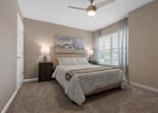 Thumbnail 4 of 21 - A bedroom with a large bed and a painting on the wall.