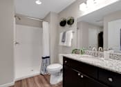 Thumbnail 17 of 23 - A bathroom with a toilet, sink, and shower.