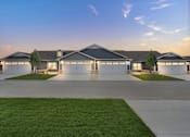 Thumbnail 8 of 23 - A modern house with a grey roof and white walls is shown with a clear blue sky in the background.