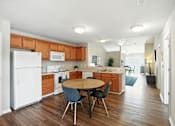 Thumbnail 7 of 15 - A kitchen with a white refrigerator and wooden cabinets.