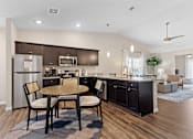 Thumbnail 4 of 20 - A modern kitchen with a dining table and chairs.
