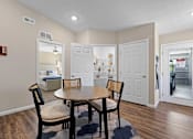 Thumbnail 5 of 20 - A dining room with a table and chairs.
