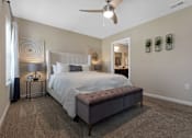 Thumbnail 11 of 20 - A bedroom with a large bed and a ceiling fan.