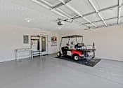 Thumbnail 20 of 20 - A golf cart is parked in a large, empty room.