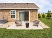 Thumbnail 16 of 18 - A house with a patio and a trash can.