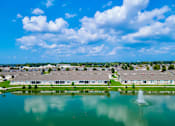 Thumbnail 9 of 18 - A large body of water with a fountain in the middle of it.