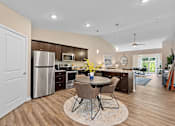 Thumbnail 5 of 18 - A kitchen with a table and chairs in the middle of the room.