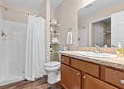 Thumbnail 16 of 20 - A bathroom with a white toilet and a white shower curtain.