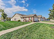 Thumbnail 3 of 20 - A house with a green lawn in front of it.