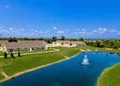 Thumbnail 19 of 19 - A beautiful aerial view of a house with a fountain in the front yard.